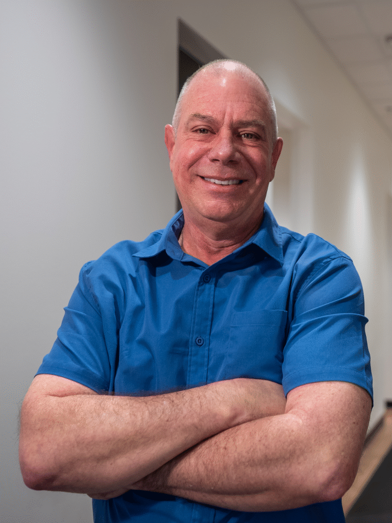 Dr Blair's patient smiling in the hallway of the practice